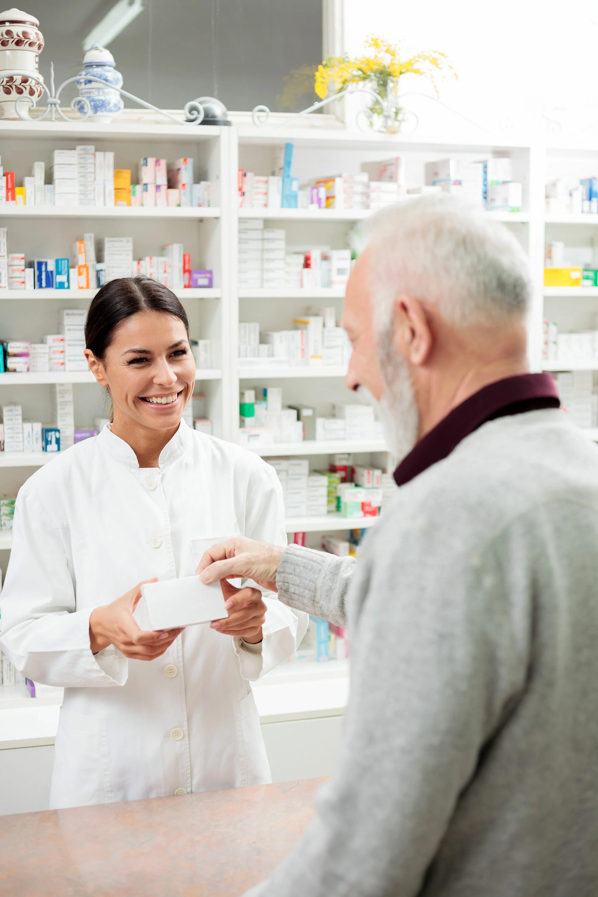 pharmacist helping an older man 
