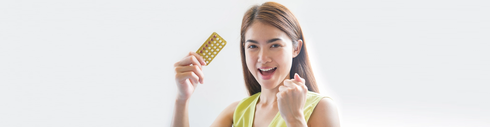woman holding contraceptive pills