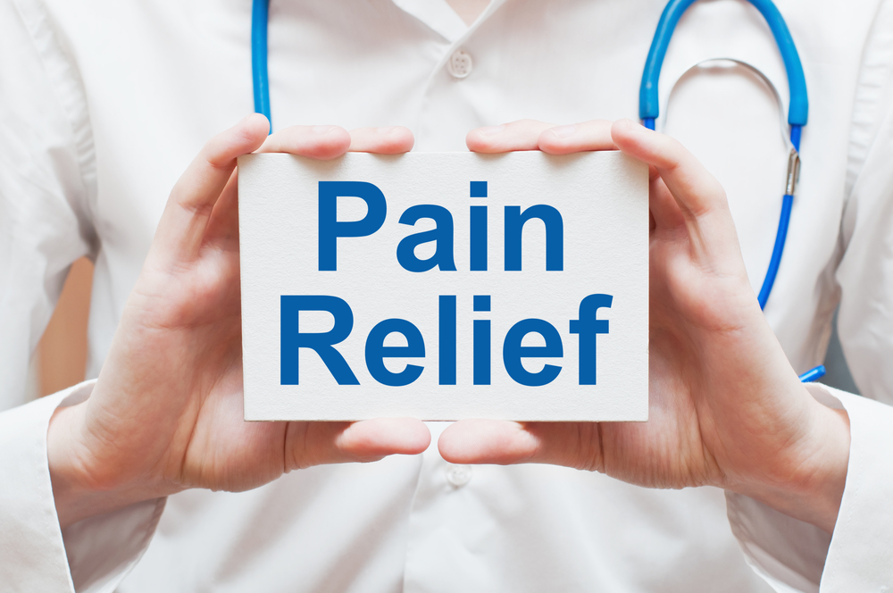 doctor holding sign that says pain relief